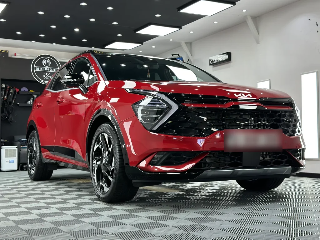 Kia Sportage roșu, din față, cu folie PPF, în atelierul Detailing Caffe din Ploiești